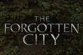  The Forgotten City is written in gold and there are green vines as the background.