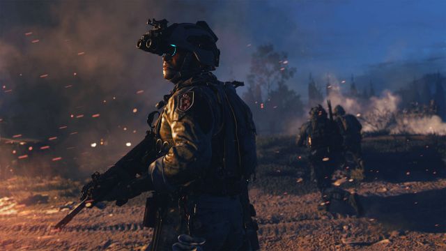 Image showing Modern Warfare player holding gun in front of fire