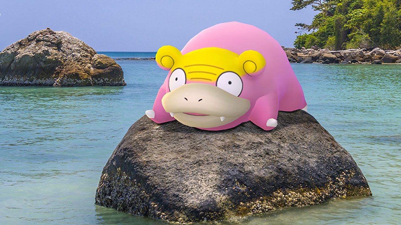 A Galarian Slowpoke, completely pink except for a yellow scalp, sits on a rock in the ocean, looking confused.