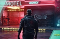 Screenshot of player in Cyberpunk 2077 approaching a futuristic motel