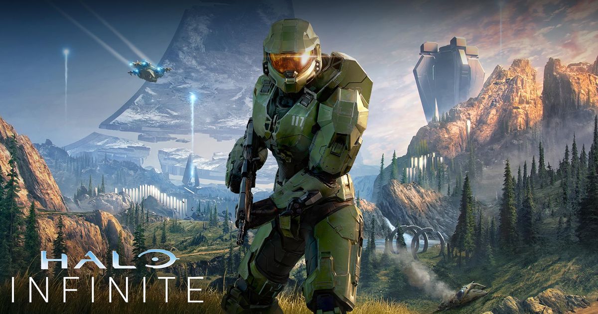 Master Chief poses in front of a battlefield in Halo Infinite