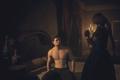 Dragon's Dogma 2 player sat on bed with character stood close by