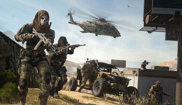 Image showing Modern Warfare 2 players standing near helicopter and atv
