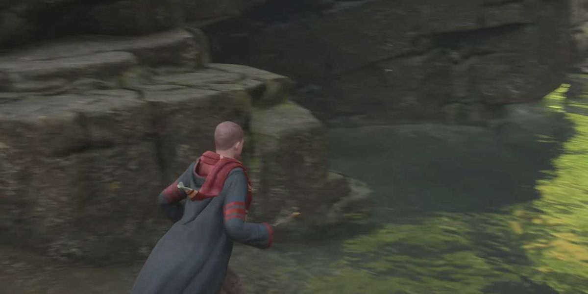 The player character getting ready to swim in Hogwarts Legacy.
