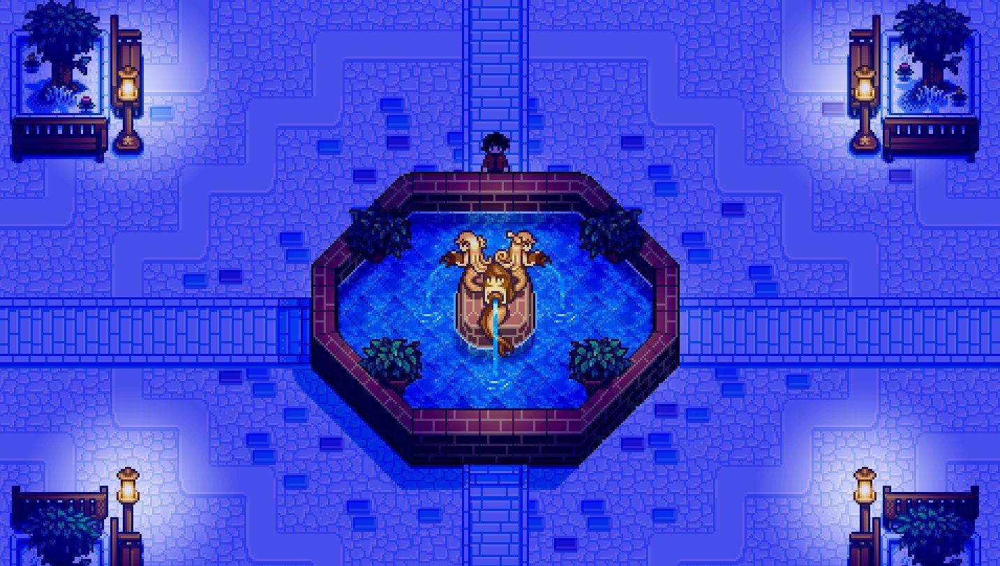 A large mermaid fountain in the middle of a town square lit by street lamps, from the game Haunted Chocolatier