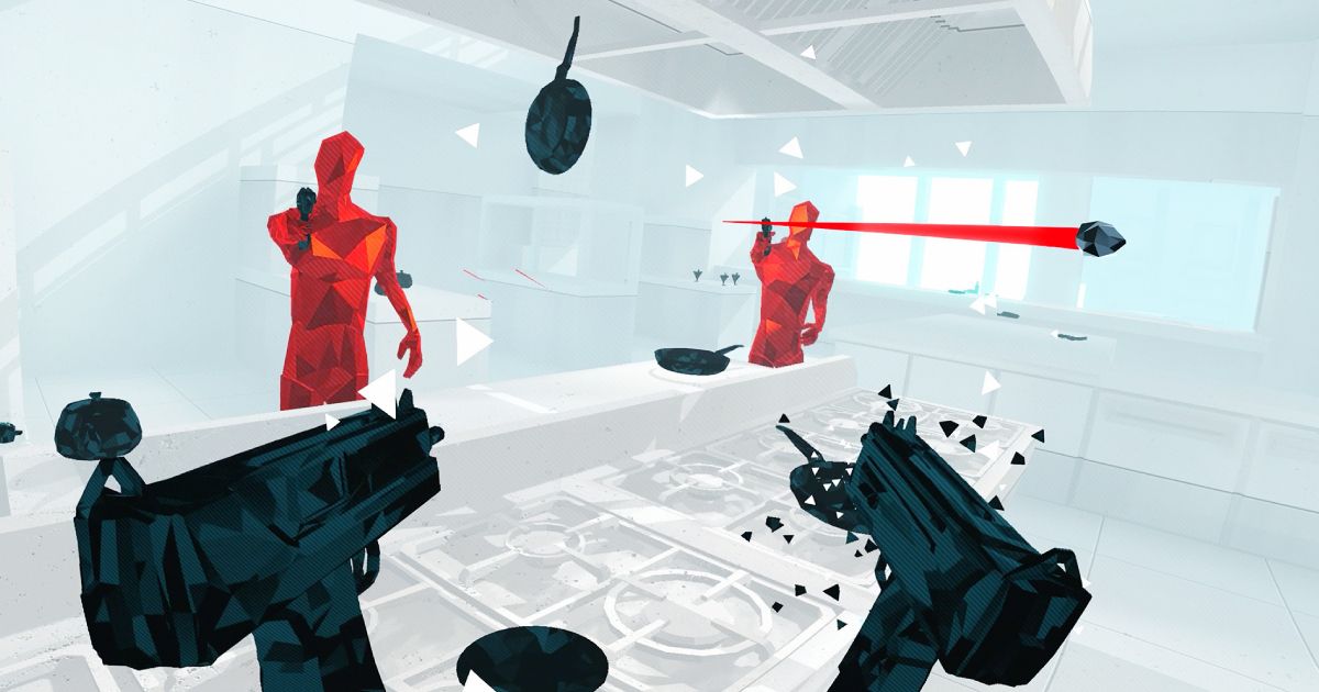 First person shot in VR of someone firing two black guns at red enemies.