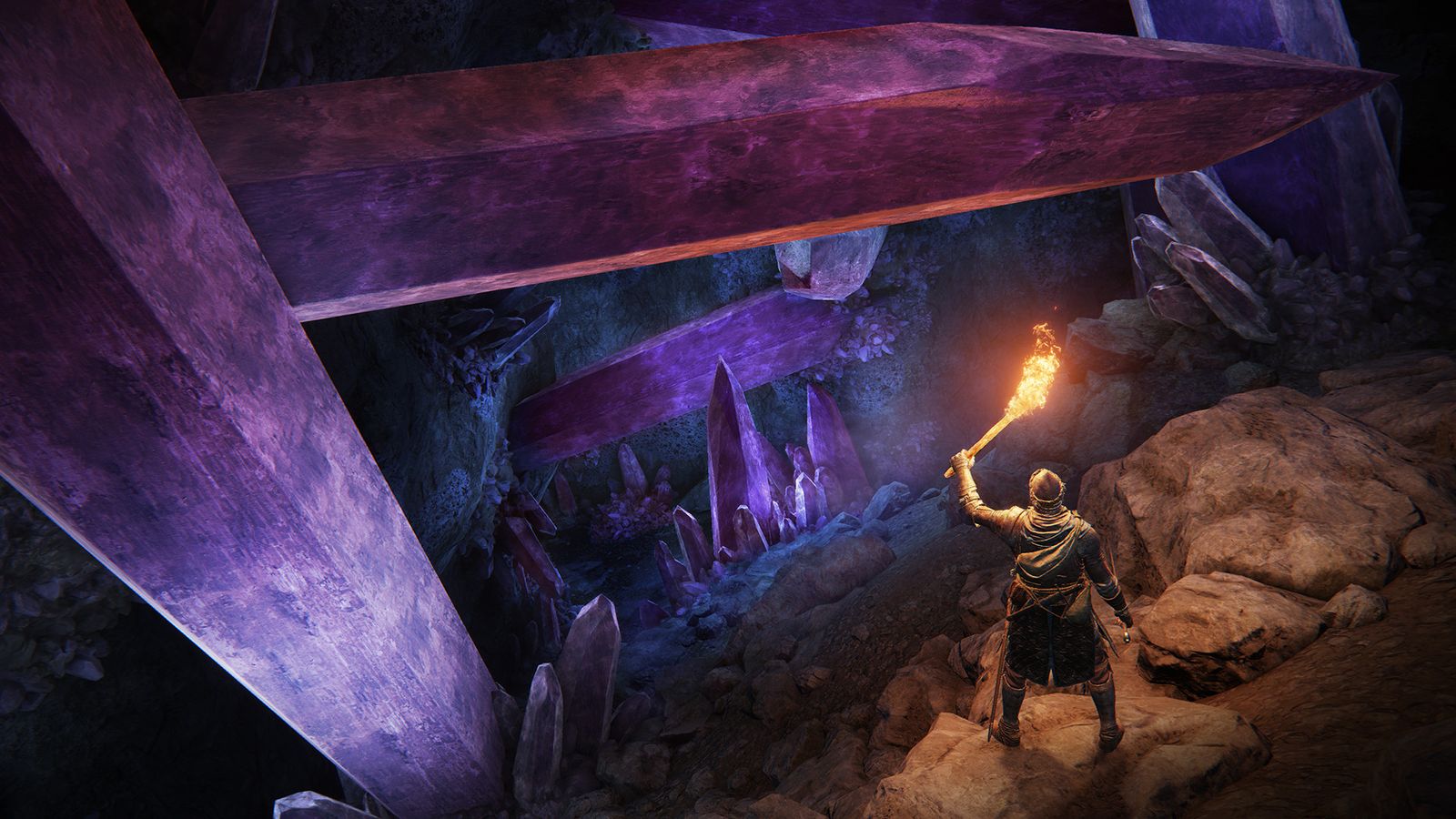A player holds up a torch, illuminating a cave filled with giant purple crystals