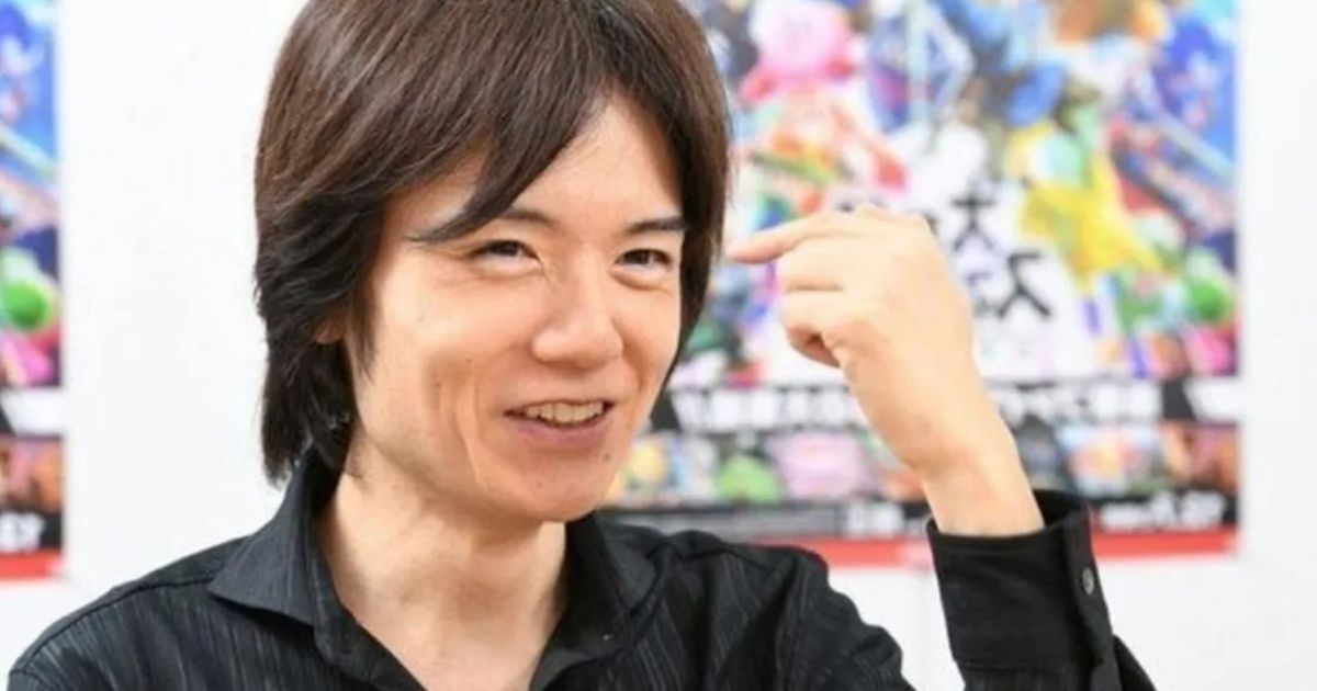 Smash Bros creator Masahiro Sakurai posing with a fist in the air in jubilation 