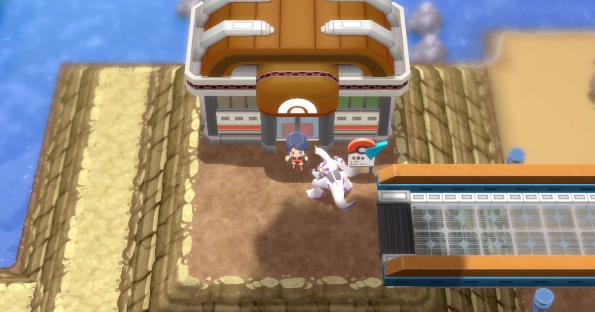 A Pokémon Trainer and their Palkia standing outside of Sunyshore City Gym in Pokémon Brilliant Diamond and Shining Pearl.