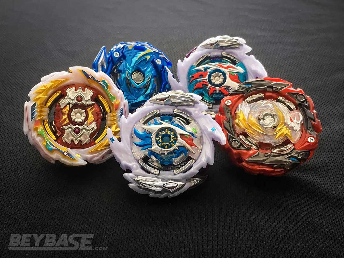 Five Beyblades are stacked together.