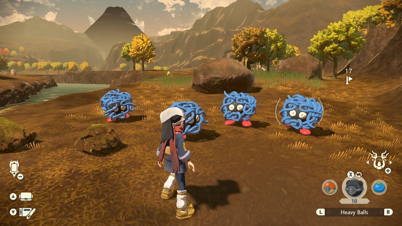 A player is fighting multiple Tangela during a Mass Outbreak in Crimson Mirelands in Pokémon Legends: Arceus.
