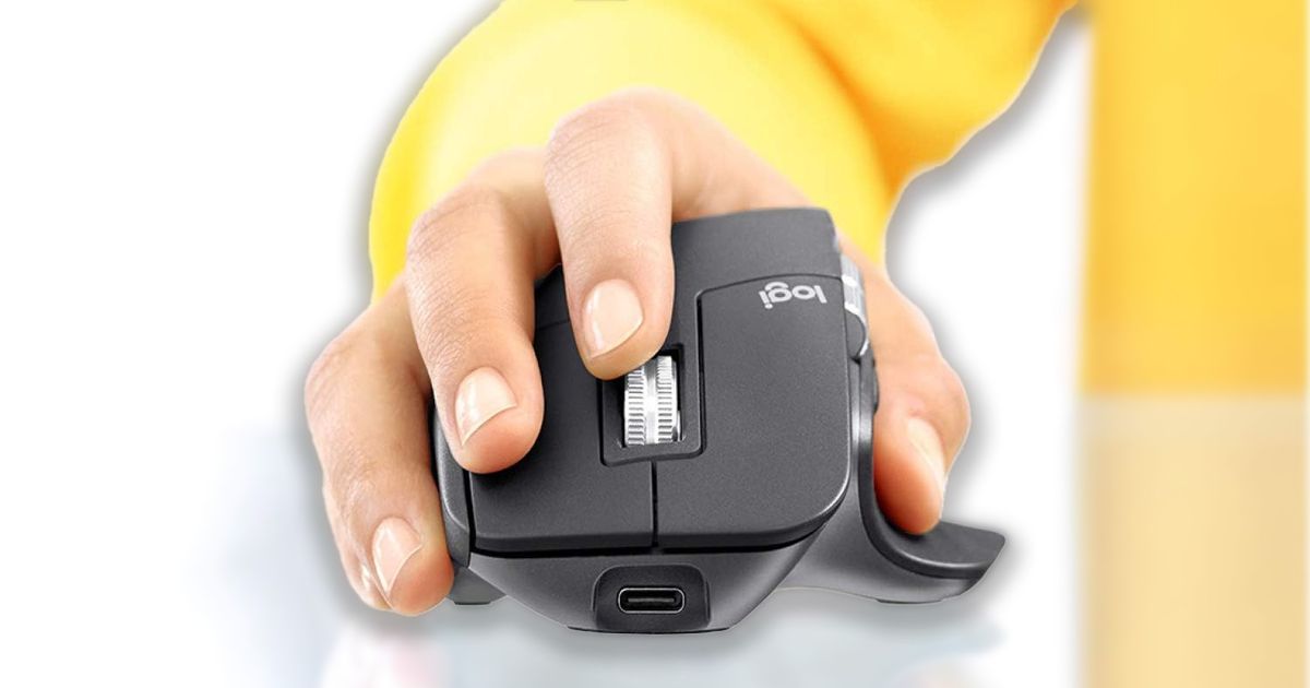 Someone in a yellow long sleeve top with their hand on a black and grey ergonomic mouse.