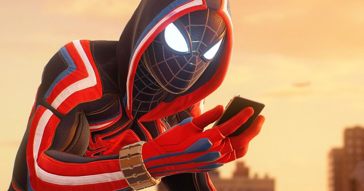 Miles Morales in a sci-fi Spider-Man costume checking his phone - captured from Spider-Man 2 on PlayStation 5