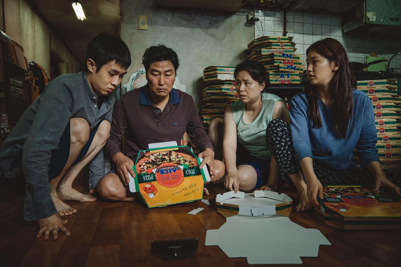 The family in Parasite is gathered around pizza boxes.