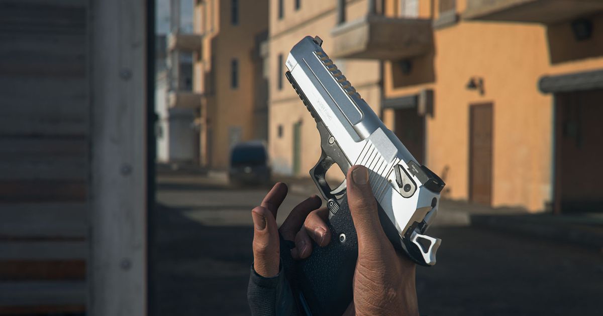 Screenshot of Modern Warfare 2 player holding GS Magna pistol by its handle in front of an orange building