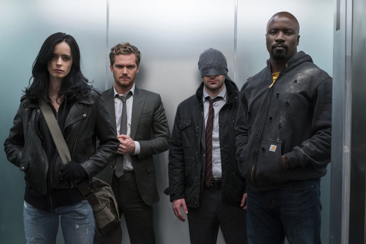 The Defenders are in an elevator and include Jessica Jones, Daredevil, Iron Fist, and Luke Cage.