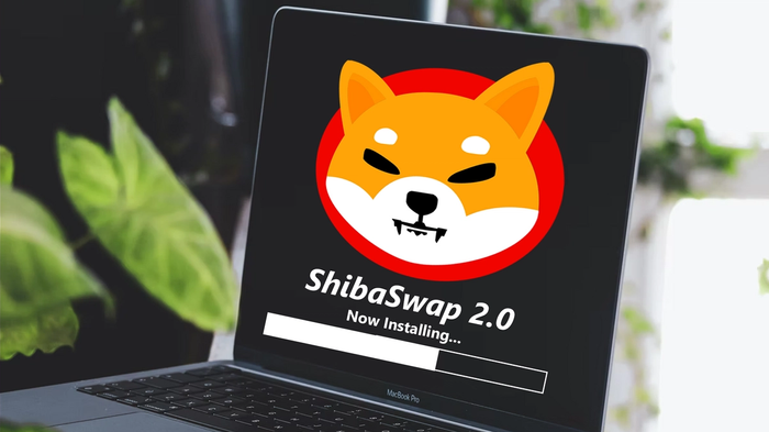 Shiba Inu (SHIB) logo on a MacBook Pro with the text ShibaSwap 2.0 Now Instaling, and a white progress bar.