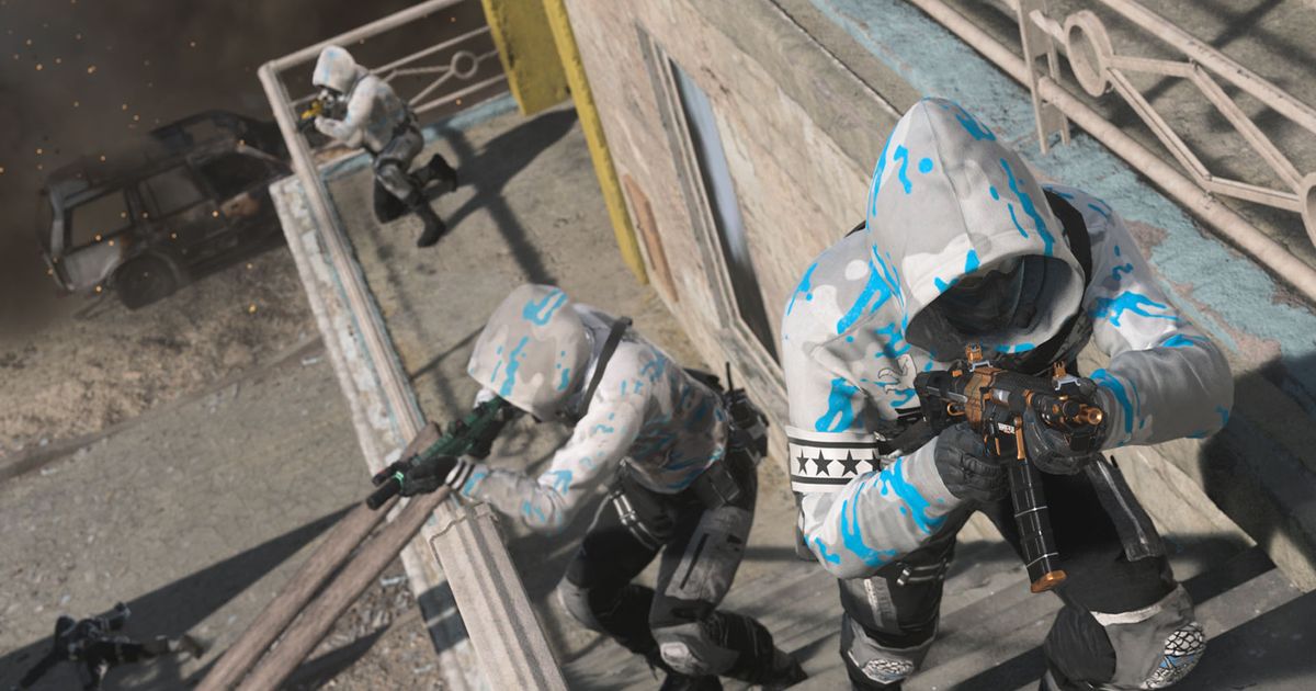 Screenshot showing Warzone 2 players advancing up staircase holding a submachine gun