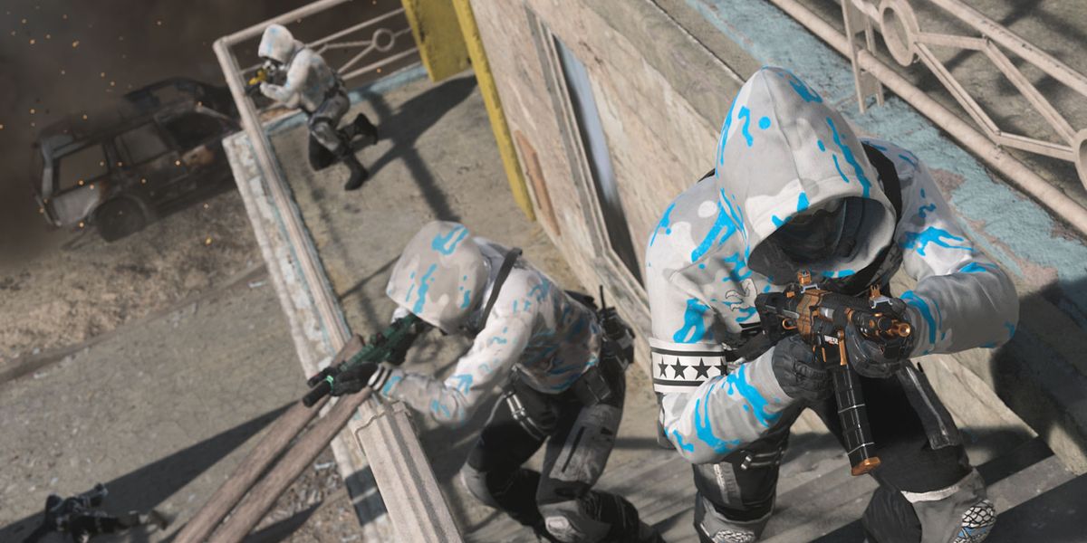 Screenshot showing Warzone 2 players advancing up staircase holding a submachine gun