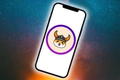 Image of a phone with a Floki Inu logo in the middle, against a blue and orange space background.