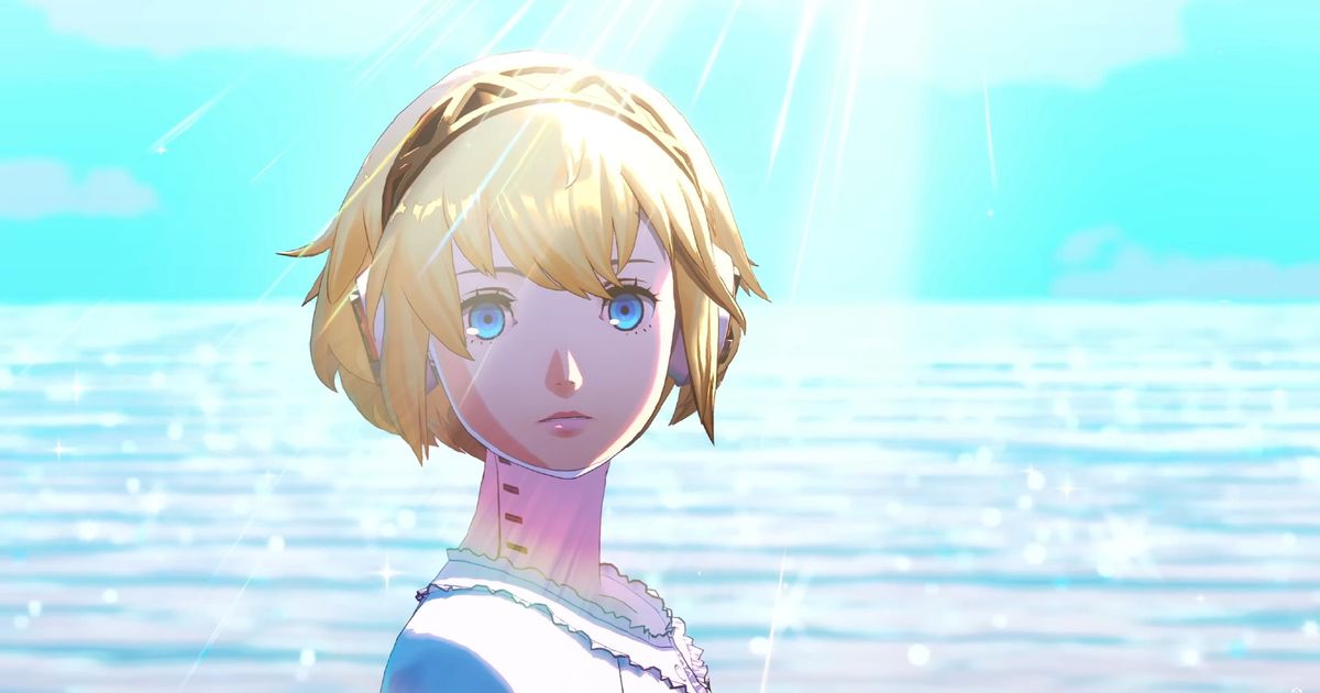 Persona 3 Reload - blonde woman with short hair looking at the camera, stood in front of the ocean