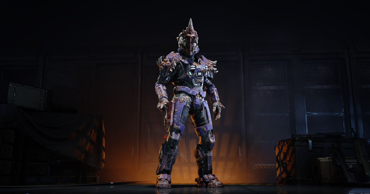 A heavily-armoured Halo character with orange light behind them.