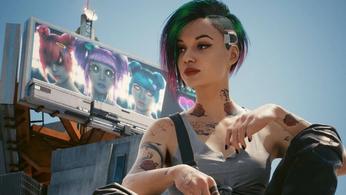 Judy is standing in front of a billboard in Cyberpunk 2077 .