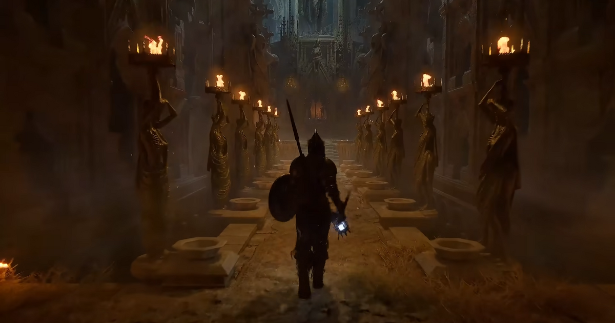 Lords of the Fallen character exploring world torches on both sides of hallway