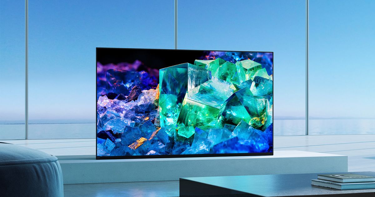 Image of a flatscreen OLED TV with crystals on the display, and the TV in front of a blue background.