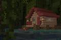 A light brown house with a darker brown roof built in a lake in a forest in Minecraft.
