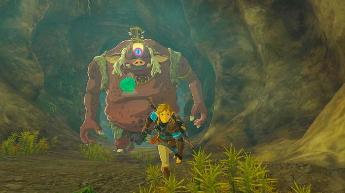 The character runs away from a huge creature in Zelda: Tears of the Kingdom.