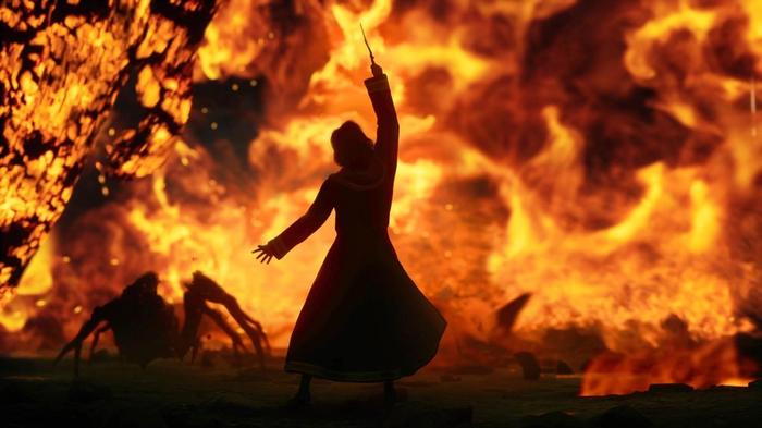 A character using a spell against a fiery backdrop in Hogwarts Legacy.