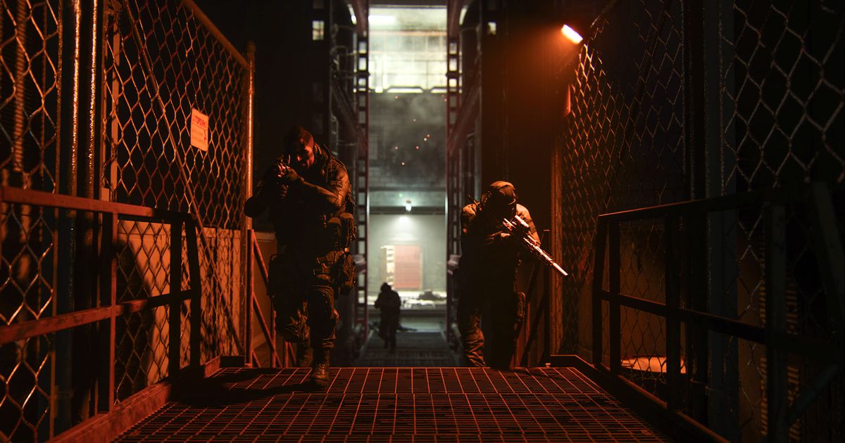 Screenshot of Modern Warfare 2 players holding guns and moving through corridor lit by dim red light